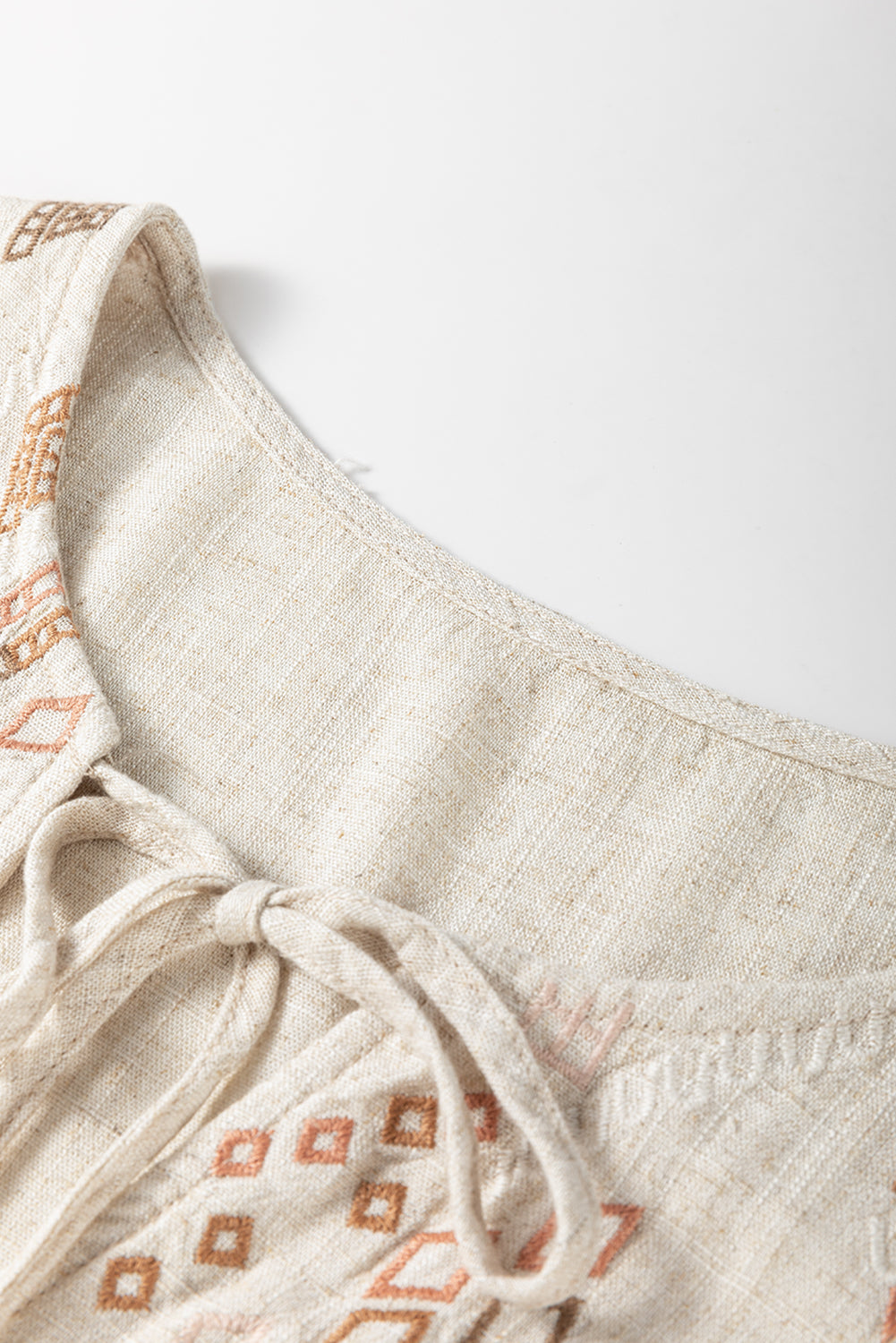 Jet Stream Geometric Embroidered Short Sleeve Tassel Tied V Neck Blouse