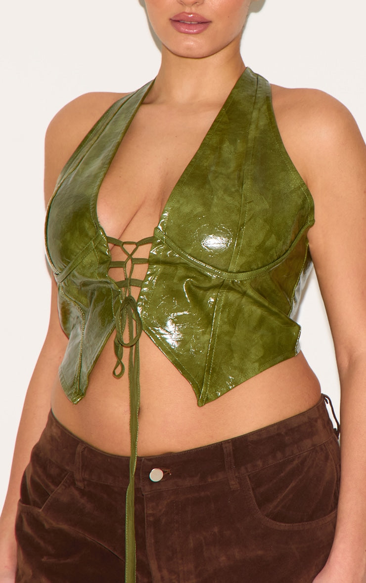 https://cdn-img.prettylittlething.com/6/c/e/b/6ceb7aad1f3e936cc7eddb47f094165c5eb0dd12_CNE0792_4_plus_olive_washed_faux_leather_lace_up_plunge_halterneck_top.jpg