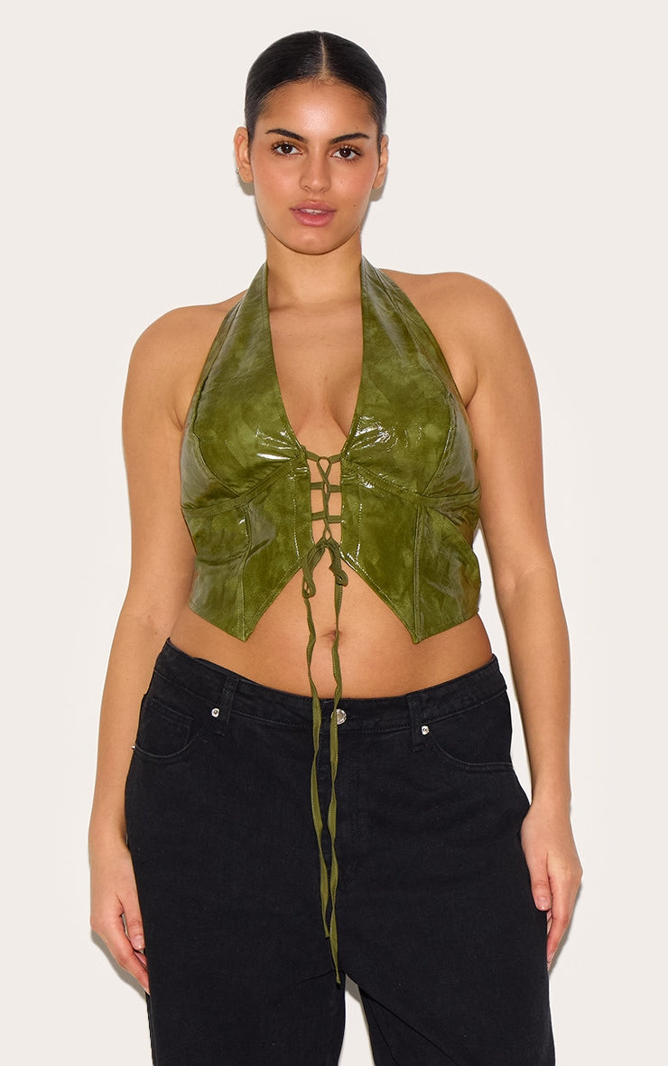 https://cdn-img.prettylittlething.com/a/1/1/d/a11dba8f1c95bca84961cd4f1135b7faf8112272_CNL8702_1_plus_washed_olive_faux_leather_lace_up_plunge_halterneck_top.jpg
